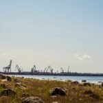 brown wooden dock on sea under blue sky during daytime